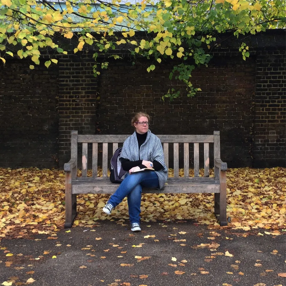 red hair woman on a park bench