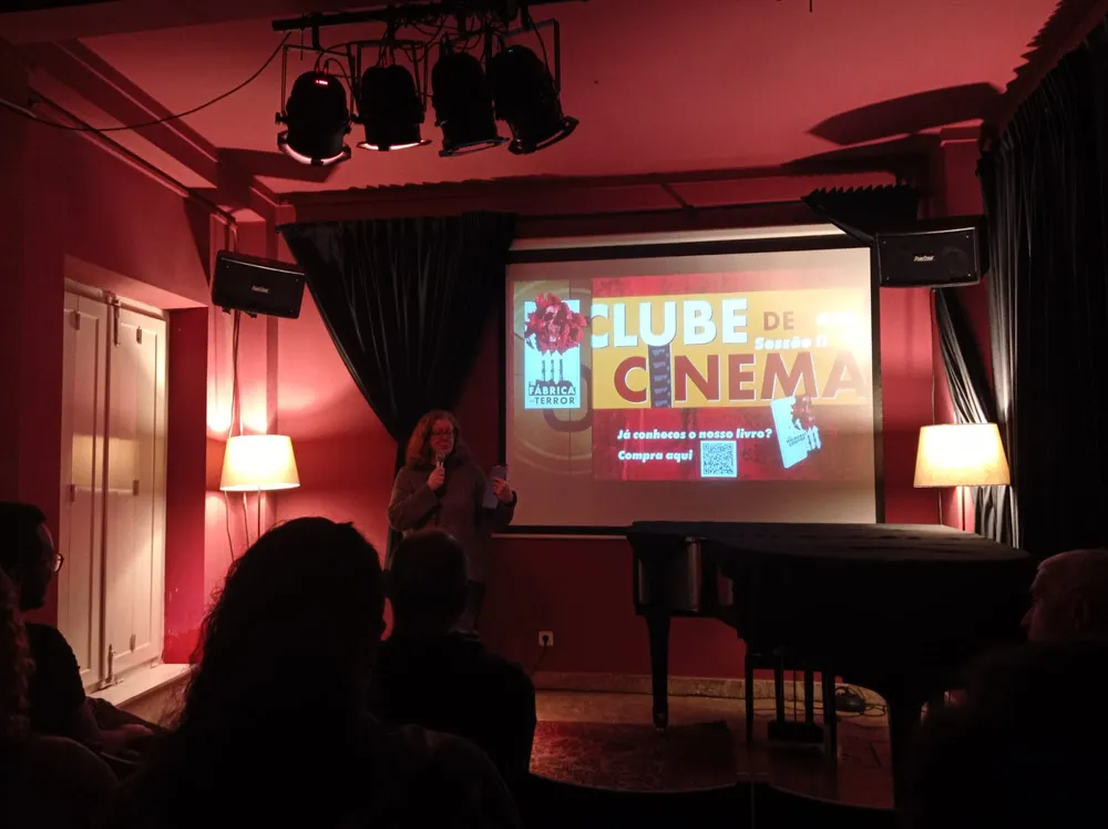 woman in a red room presenting something